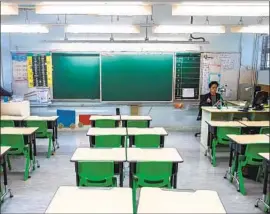  ?? Isaac Lawrence AFP/Getty Images ?? IN HONG KONG, primary school teacher Billy Yeung records a video lesson. Public schools have been closed since the Lunar New Year vacation began Jan. 22.