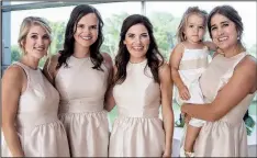  ??  ?? Chandler Bailey, sister of the groom; Geri Bemberg, cousin of the bride; Caroline Holt, sister of the bride; and Callie Gutierrez, sister of the groom, holding her daughter Eva