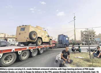  ??  ?? military convoy carrying u.s.–made oshkosh armoured vehicles, with flags bearing pictures of PKK leader abdullah Öcalan, en route to raqqa for delivery to the YPG, passes through the syrian city of Qamishli, sept. 19.