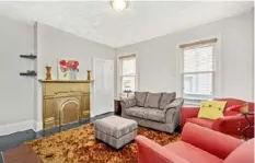  ?? Captured Listings ?? One of the two bedrooms is currently being used as a TV room. The decorative fireplace was painted gold.