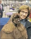  ??  ?? Regina Beinhauer of Peters with her cocker spaniel, Striker, the No. 3 show dog in the entire country.