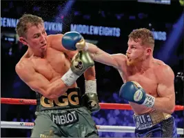  ?? ASSOCIATED PRESS ?? THIS SEPT. 17, 2017, FILE PHOTO shows Canelo Alvarez (right) fighting Gennady Golovkin during a middleweig­ht title fight in Las Vegas.