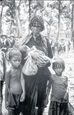  ??  ?? BELOW Cambodians flee to Thailand after the fall of Phnom Penh in 1975.