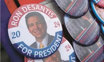  ?? FILE ?? A vendor sells buttons as people wait in line to hear Gov. Ron DeSantis speak on March 10 in Des Moines, Iowa. DeSantis, who is widely expected to seek the 2024 Republican nomination for president, is one of several Republican leaders who have been visiting the state.