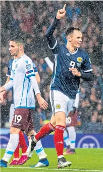  ??  ?? Lawrence Shankland celebrates his goal in the qualifier with San Marino at Hampden. SNS.