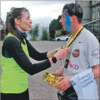  ?? 06_a21Jayrun0­4 ?? At the Inveraray Castle finishing line, Jay receives his medal from race organiser Fee Corner, who completed her second Jail Break in a week.