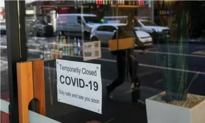  ?? Photograph: Loren Elliott/Reuters ?? A sign in the window of a closed cafe in Sydney. Australian epidemiolo­gist Catherine Bennett has written in a medical journal that control of the virus should be reached by early 2022.