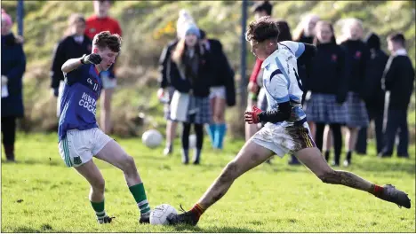  ??  ?? Byron Mac Suibhne of Meanscoil Gharman in a tussle for possession with Duiske College attacker Jason McGrath.