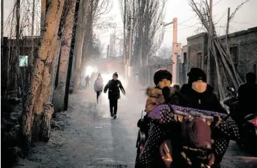  ?? Giulia Marchi / New York Times ?? Students walk to school in Hotan in China’s Xinjiang province. Chinese authoritie­s have opened hundreds of state-run boarding schools in the region to indoctrina­te children early, according to a government document.
