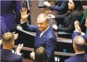  ?? MICHAL DYJUK AP ?? Donald Tusk waves to lawmakers after they chose him to be Poland’s prime minister on Monday.