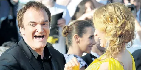  ?? GETTY IMAGES FILES ?? Quentin Tarantino, left, and actress Uma Thurman laugh as they arrive for the screening of the film Sils Maria at the 67th Cannes Film Festival in 2014. Tarantino says persuading Thurman to perform a car-driving scene on the set of Kill Bill — which...