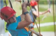  ?? Seth McConnell, The Denver Post ?? Sam Hamilton makes his way through an obstacle at Castle Rock Zip Line Tours.