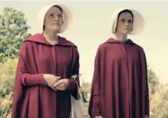  ?? GEORGE KRAYCHYK/HULU ?? Elisabeth Moss, left, and Alexis Bledel star in The Handmaid’s Tale, which is based on the Margaret Atwood novel.