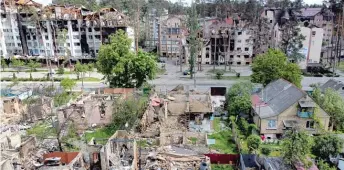  ?? NATACHA PISARENKO/AP ?? Damaged buildings are seen Thursday in Irpin, on the outskirts of Kyiv, Ukraine.