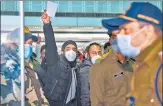  ?? AFP ?? One of the passengers arriving from Italy waves as he waits to undergo a Covid screening, at Amritsar airport.