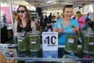  ?? THE ASSOCIATED PRESS ?? Vendors offer marijuana for sale at the High Times Cannabis Cup in San Bernardino.