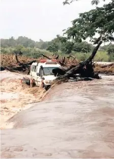  ?? ZIMBABWE RED CROSS SOCIETY FACEBOOK ?? AN EMERGENCY vehicle lies stuck against a tree in raging waters in the province of Manicaland in eastern Zimbabwe at the weekend. Dozens are missing after roads and houses were washed away when Cyclone Idai hit the country. The cyclone also led to several fatalities and destructio­n in parts of Malawi and Mozambique. Authoritie­s say about 150 people have been killed. |