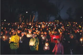  ?? Canadian Press photo ?? Hundreds of people hold candles in support and memory of Aubrey Berry, 4, and her sister Chloe, 6, during a vigil held at Willows Beach in Oak Bay, B.C., on Dec. 30.