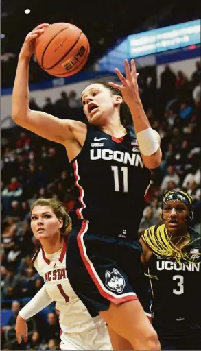  ?? Tyler Sizemore / Hearst Connecticu­t Media ?? Lou Lopez Senechal (11) pulls down a rebound in UConn’s win over NC State in Hartford on Sunday.