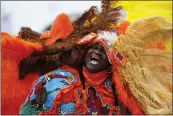  ?? GERALD HERBERT — THE ASSOCIATED PRESS ?? Big Chief Cantrell Watson, of the New Orleans Mardi Gras Indian tribe Wild Mohicans, chants as he parades through the New Orleans Jazz & Heritage Festival in New Orleans, Friday.