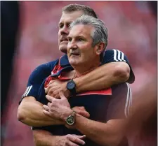  ??  ?? Kieran Kingston is embraced by selector Diarmuid O’Sullivan as they watch the final moments of the Munster Final between Clare and Cork at Semple Stadium, Thurles last July