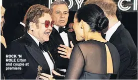  ??  ?? ROCK ‘N ROLE Elton and couple at premiere