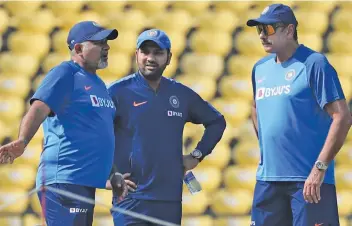  ??  ?? (From left) India bowling coach Bharat Arun, captain Rohit Sharma and head coach Ravi Shastri are in an animated discussion during a training session in Nagpur on Saturday. — AP