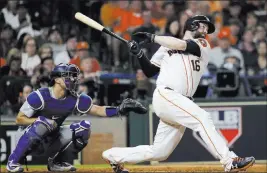  ?? David J. Phillip ?? The Associated Press Brian Mccann of the Astros hits a home run against the Dodgers during the eighth inning of Game 5 on Sunday night in Houston.