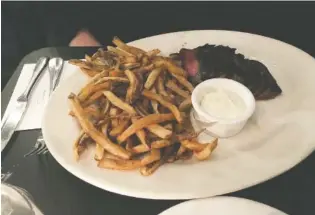  ?? PHOTO BY JIM TANNER ?? Steak frites served with Wagyu beef and miso butter.