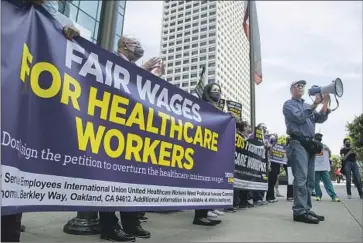  ?? Myung J. Chun Los Angeles Times ?? DEMONSTRAT­ORS rally last month in downtown Los Angeles to seek higher pay for healthcare workers.