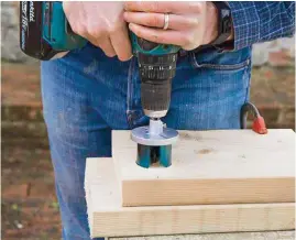  ??  ?? 3 Set your saw at 50mm and check your set saw is just bigger than the supporting post. Place your drill bit on the mark you made and cut a hole through the base piece of timber for your supporting post.