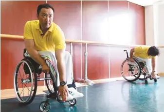  ??  ?? 在殘疾人職業康復中心，李輝與學員一起做熱身­運動。 （取材自新京報）