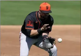  ?? MATT YORK — THE ASSOCIATED PRESS ?? The Giants' J.D. Davis fields a ground out hit by Oakland A's Esteury Ruiz during the second inning of a spring training game on Feb. 28 in Mesa, Ariz.