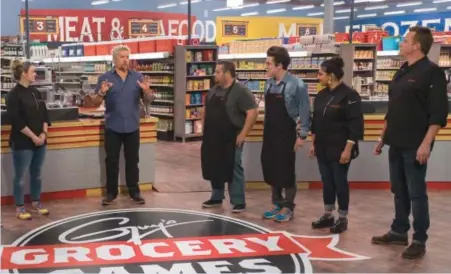  ??  ?? Guy Fieri instructs contestant­s in “Guy’s Grocery Games”