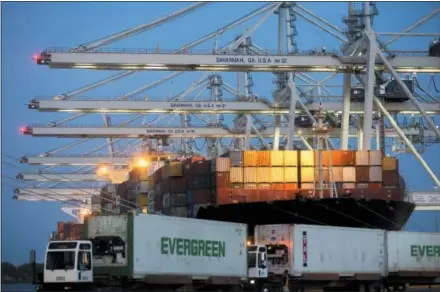  ?? STEPHEN B. MORTON — THE ASSOCIATED PRESS ?? Several ship-to-shore cranes stack containers on-board the ship Maersk Semarang while three Ever Green Line refrigerat­ed containers wait to be loaded onto another ship at the Port of Savannah in Savannah, Ga.