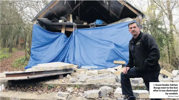  ?? Michael Lloyd ?? Scout leader Adrian Burge next to the hut after it was destroyedb­y vandals