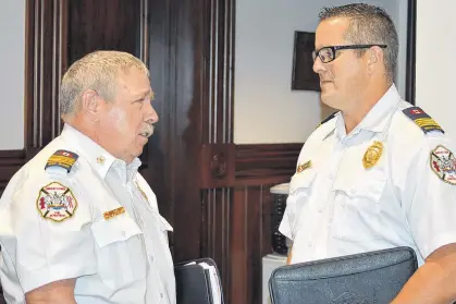  ?? DAVE STEWART/THE GUARDIAN ?? Charlottet­own Deputy Fire Chief Tim Mayme, right, says the department currently has two fire inspectors working to identify owners of apartment buildings that still have propane or charcoal barbecues on patio decks. He’s pictured here with Fire Chief Randy MacDonald after Tuesday’s monthly meeting of council’s protective and emergency services meeting.