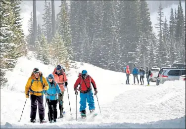  ?? Helen H. Richardson / The Denver Post ?? Brian Mccarthy, left, leads his group as they head out for a day of skiing in the backcountr­y near Jones Pass near Empire on Thursday. Many mountains can expect to receive 5-10 inches of snow this weekend.