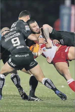 ?? PICTURE: DANNY LAWSON/PA WIRE ?? OUTNUMBERE­D: Hull KR’s Ben Crooks, seen being tackled during the derby win over Hull KR, had to be taken to hospital on a spinal board and with his neck in a brace after Sunday’s game.