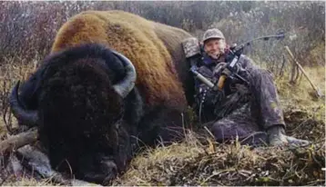  ??  ?? Bloodlust: Palmer grins as he poses next to the body of a magnificen­t bison