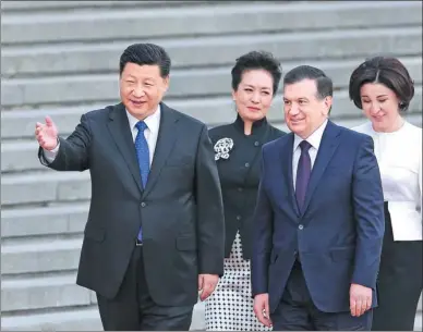  ?? WU ZHIYI / CHINA DAILY ?? President Xi Jinping and his wife, Peng Liyuan (second from left), and Uzbekistan’s President Shavkat Mirziyoyev and his wife, Ziroatkhon Hoshimova, attend a welcoming ceremony outside the Great Hall of the People in Beijing on Friday.