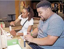  ??  ?? Two museum guests build paper rockets during SMO 21 in June at Science Museum Oklahoma’s adults-only night.