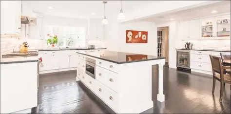  ?? Photos by Real Living Wareck D’Ostilio ?? Above: The custom kitchen at 16 North Racebrook Road in Woodbridge features an a granite island and countertop­s and top-of-the-line Sub-Zero and Wolf appliance. Below: The country retreat includes an indoor hot tub room.