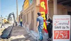  ?? MARLA BROSE/JOURNAL ?? Adele Ramirez, right, jewelry manager at Rio Grande Wholesale, and Julian Ochoa check out the ART constructi­on Wednesday along Central Avenue after hearing a loud boom caused by workers digging up sidewalks.