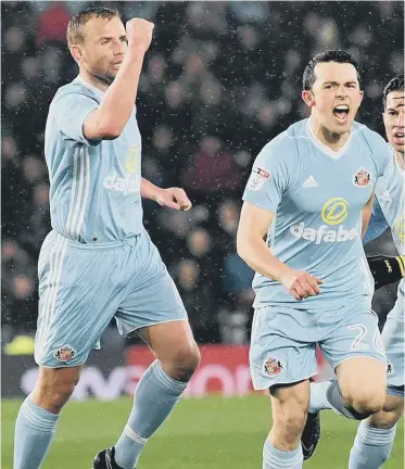  ??  ?? Goerge Honeyman (centre) enjoys his deflected opening goal in Good Friday’s stunning win at Derby County. Inset: Sunderland’s absent owner Ellis Short.