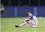  ?? REBECCA BLACKWELL/ ASSOCIATED PRESS ?? U.S. soccer player Matt Besler sits on the pitch after the Americans’ stunning 2-1 loss to Trinidad and Tobago on Tuesday, helping to eliminate the team from getting a World Cup berth.