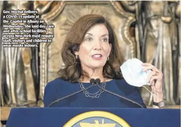  ??  ?? Gov. Hochul delivers a COVID-19 update at the Capitol in Albany on Wednesday. She said day care and after-school facilities across New York must require staff, visitors and children to wear masks indoors.