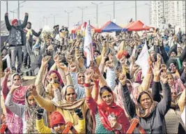  ?? ANI ?? Farmers raise slogans in an ongoing protest against the new farm laws, at the Delhi-Ghazipur border on Wednesday.