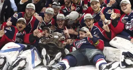  ?? ADRIAN WYLD/THE CANADIAN PRESS ?? The Windsor Spitfires celebrate after winning the Memorial Cup on Sunday. Leafs prospect Jeremy Bracco, sitting front right, set up the winning goal.