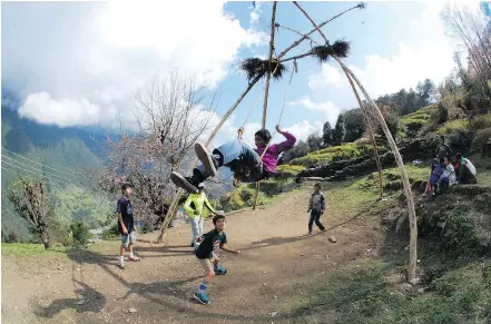  ?? — AP FILES ?? Interactin­g with local residents, some of whom can speak English, can be a rewarding and educationa­l experience for children who travel with their parents to villages like Ulleri in central Nepal.